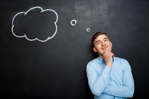 Smiling Bearded Man Shouting And Standing Over Blackboard Backgr