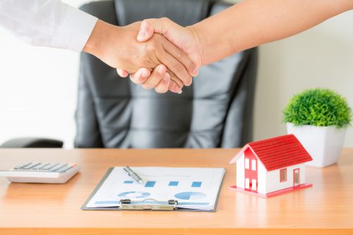 Hands Of Agent And Client Shaking Hands After Signed Contract Bu
