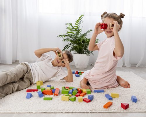 Non Binary Kids Playing With Colorful Game