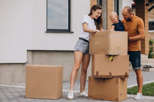 Young Family With Little Daughter Moving Into New House